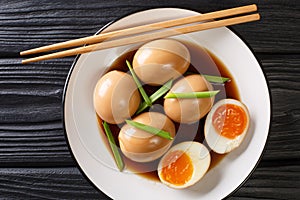 NitamagoÃÂ is a boiledÃÂ eggÃÂ in savory sauce close-up in a plate. Horizontal top view photo